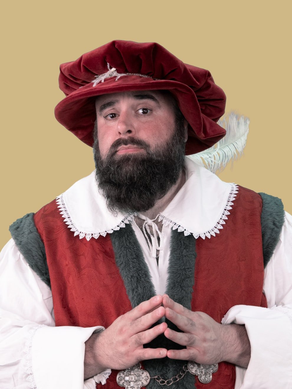 Portret van een man in Hanzekleding met rode hoed.