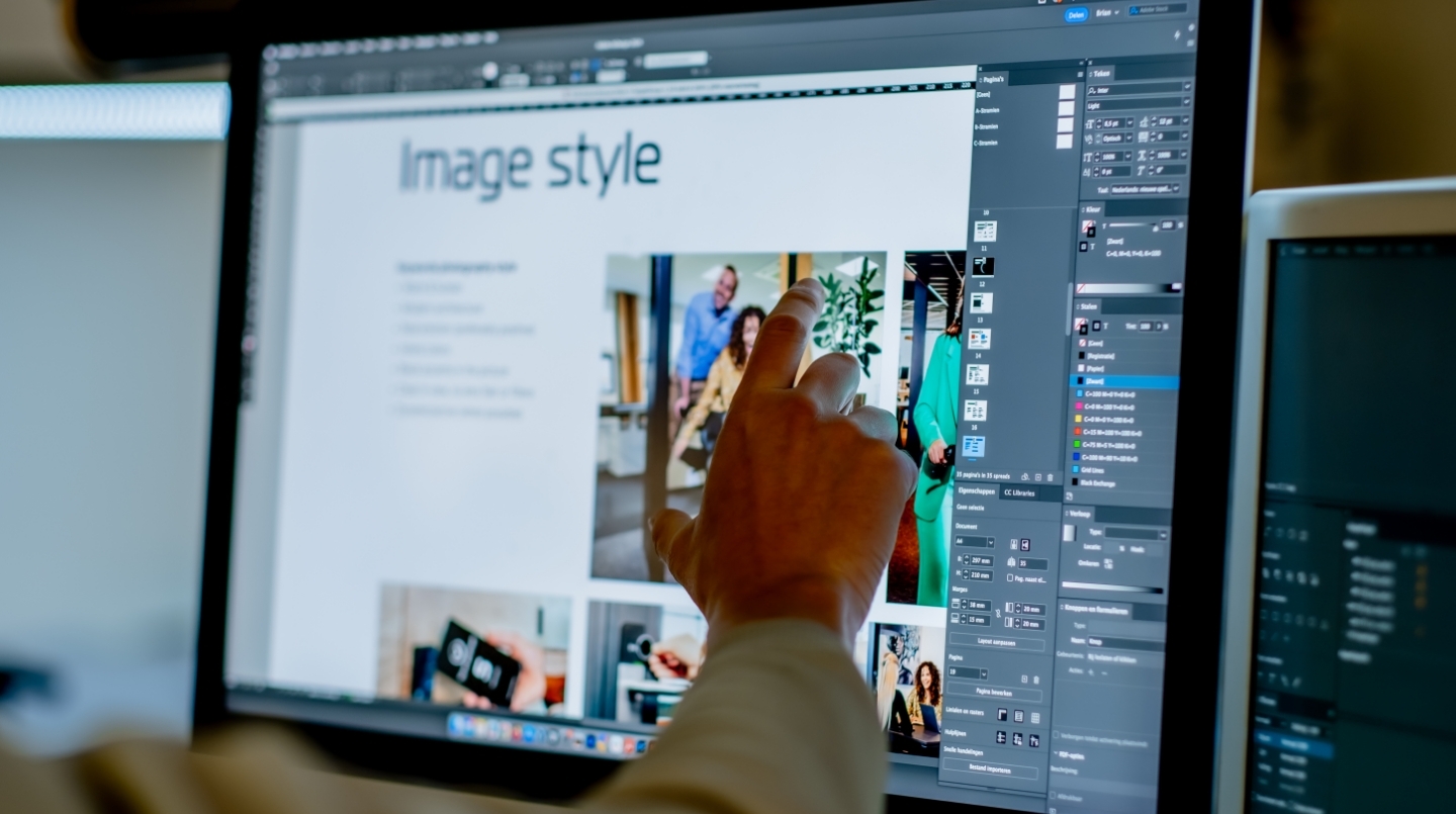 Persoon werkt aan rebranding op computerscherm met beeldbewerkingsprogramma.